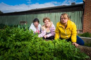 Three women in a community garden