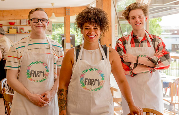 Three adult learners in aprons