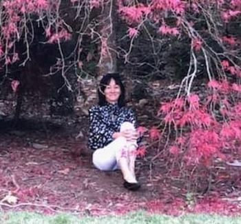 Woman sitting under tree